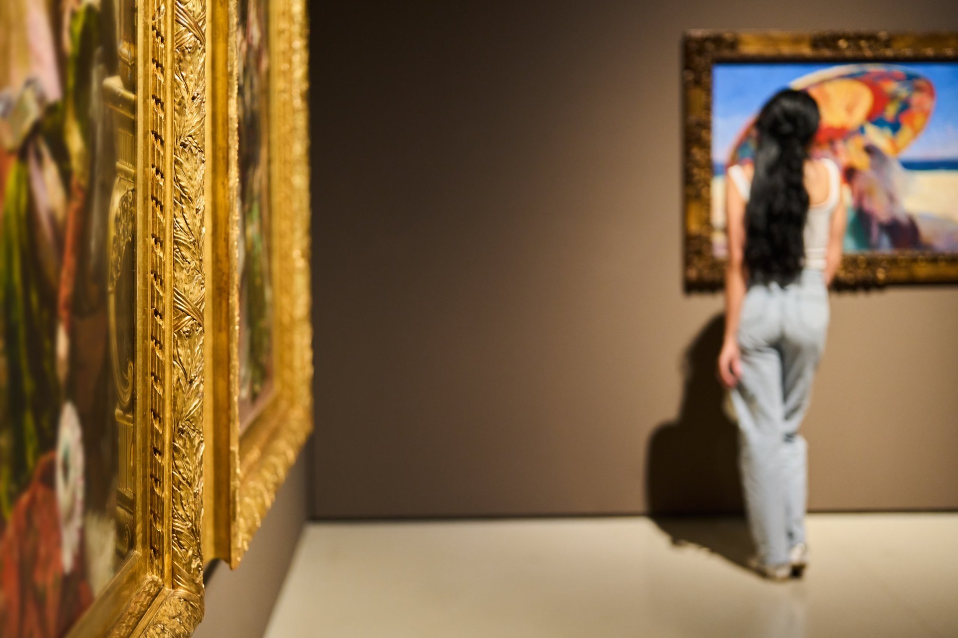 Women in the museum looks at art gallery