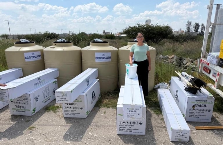 Person standing among large water storage tanks and white supply boxes in an outdoor industrial area