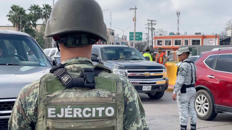 Mexican Army soldier from behind wearing camouflage uniform at a checkpoint